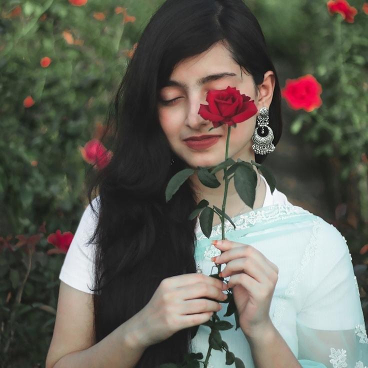 Maya Chen, Lead Design Curator at SpruceMossBreeze, reviewing corporate floral arrangements